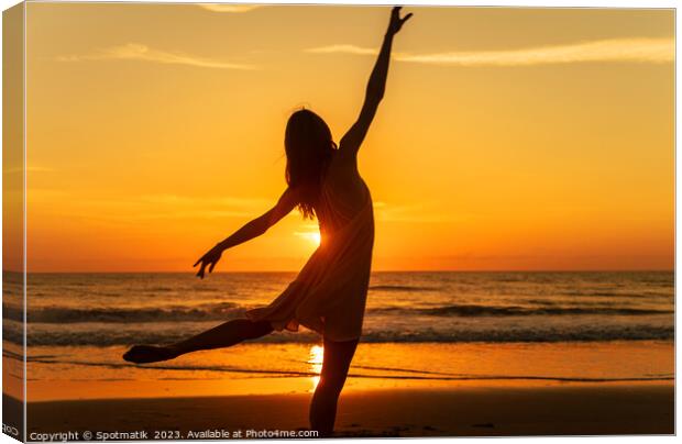 Sunset view carefree young girl dancing on beach Canvas Print by Spotmatik 