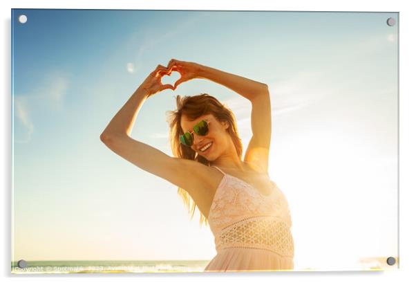 Bohemian girl showing heart sign dancing on beach Acrylic by Spotmatik 