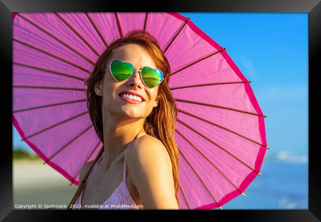 Hippy chic with parasol smiling in beach vacation Framed Print by Spotmatik 