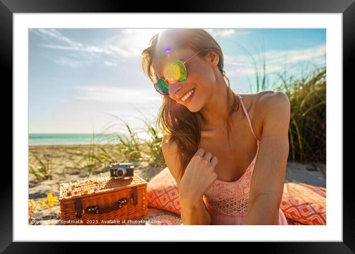 Smiling Caucasian girl relaxing on blanket at beach Framed Mounted Print by Spotmatik 