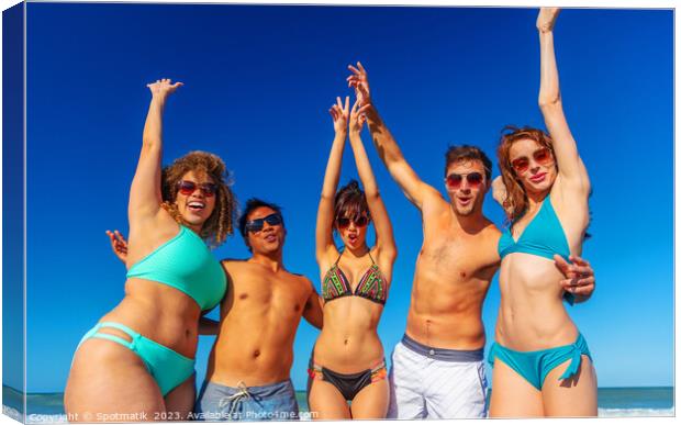 Beach party fun friends in swimwear enjoying vacation Canvas Print by Spotmatik 