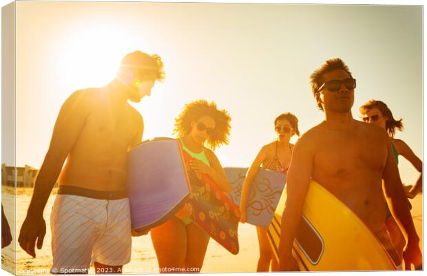 Group of friends with bodyboards on beach vacation Canvas Print by Spotmatik 