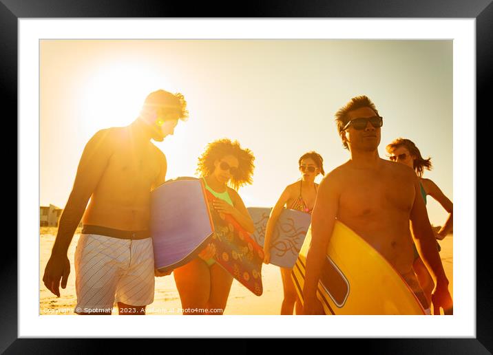 Group of friends with bodyboards on beach vacation Framed Mounted Print by Spotmatik 