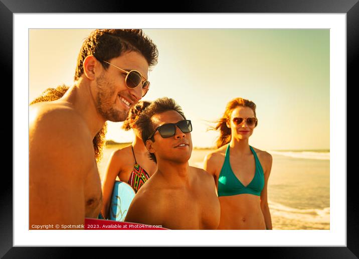Friends on beach going bodyboarding on Summer vacation Framed Mounted Print by Spotmatik 