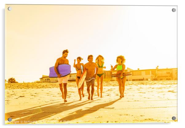 Friends in swimwear running carrying bodyboards on beach Acrylic by Spotmatik 