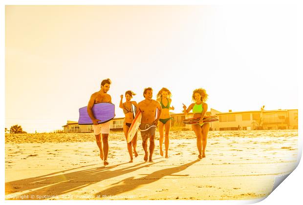 Friends in swimwear running carrying bodyboards on beach Print by Spotmatik 