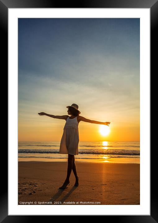 African American woman dancing on beach at sunset Framed Mounted Print by Spotmatik 