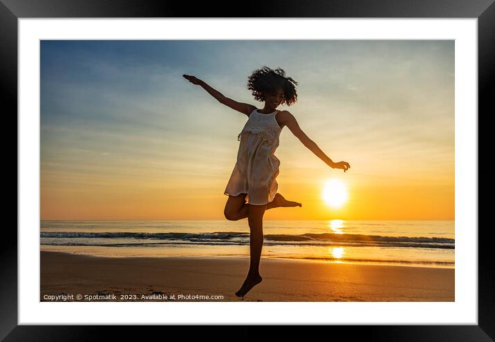 Barefoot young African American woman dancing on beach Framed Mounted Print by Spotmatik 