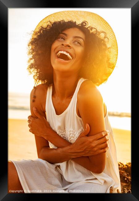 Laughing Afro American female wearing hat on beach Framed Print by Spotmatik 
