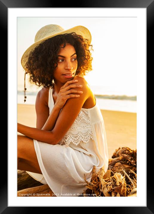 Solo African American woman sitting on beach driftwood Framed Mounted Print by Spotmatik 