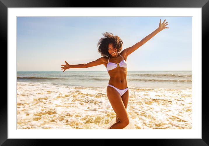 African American girl enjoying Summer fun in ocean Framed Mounted Print by Spotmatik 
