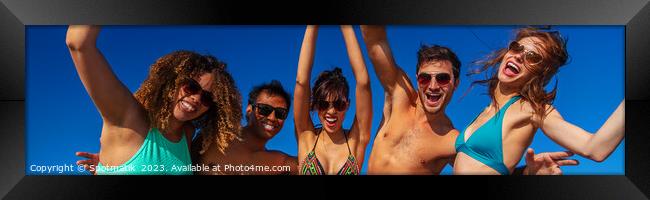 Panoramic view of friends having fun on beach Framed Print by Spotmatik 