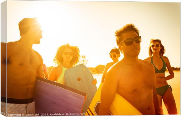 Friends in swimwear carrying bodyboards enjoying Summer vacation Canvas Print by Spotmatik 