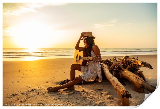Indian female sitting on driftwood with ocean sunrise Print by Spotmatik 
