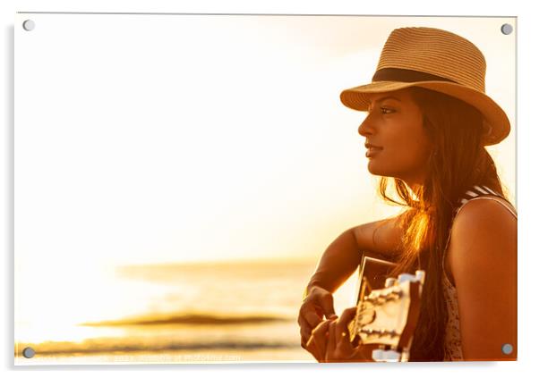 Indian woman wearing hat playing guitar on beach Acrylic by Spotmatik 