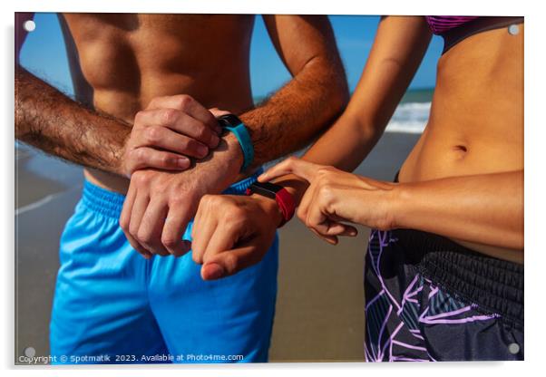Fit young couple on beach setting activity trackers Acrylic by Spotmatik 