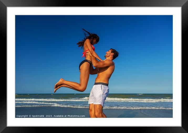Male and female in swimwear enjoying Summer fun Framed Mounted Print by Spotmatik 
