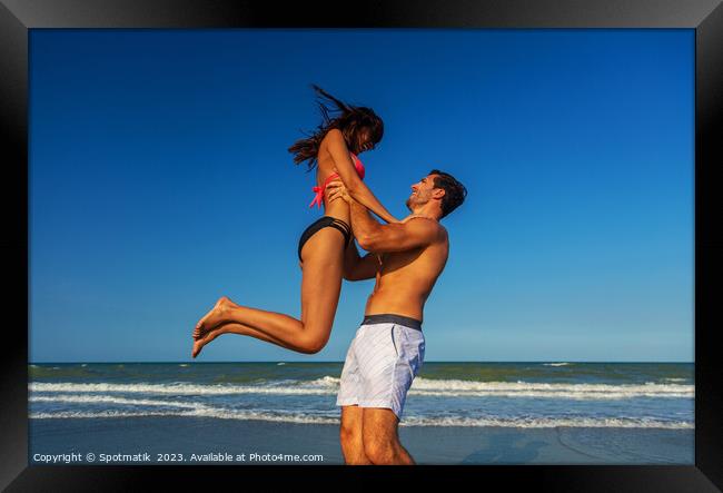 Male and female in swimwear enjoying Summer fun Framed Print by Spotmatik 