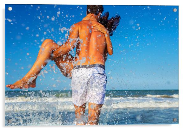 Fun loving ethnic couple running in ocean waves Acrylic by Spotmatik 