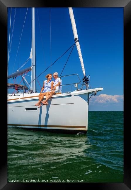 Loving retired couple relaxing together on luxury yacht Framed Print by Spotmatik 