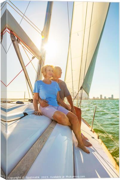 Senior couple enjoying togetherness on yacht at sunset Canvas Print by Spotmatik 