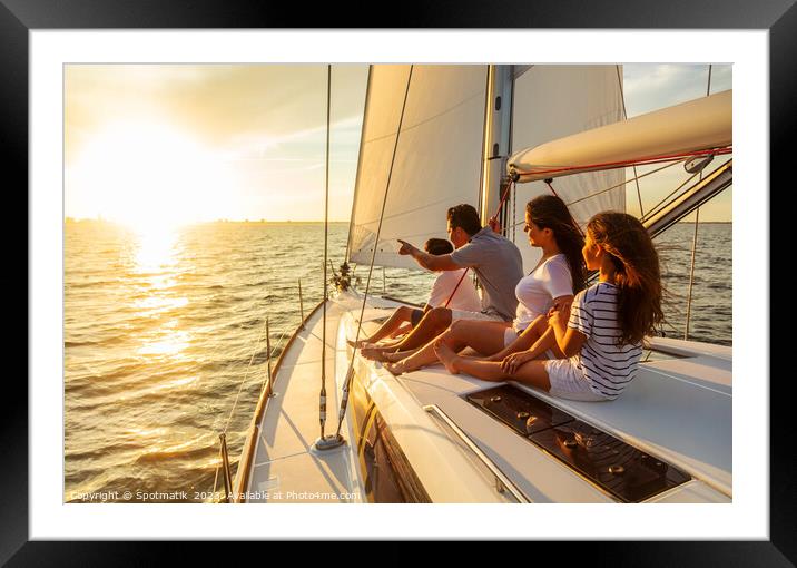 Relaxed family on luxury yacht sailing towards sunset Framed Mounted Print by Spotmatik 