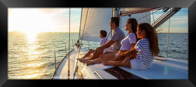 Panorama of Latin American family on sailing vacation at sunset Framed Print by Spotmatik 