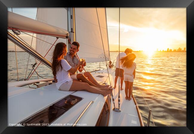 Young family having fun on yacht at sunset Framed Print by Spotmatik 