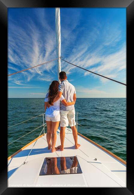 Loving young Latino couple standing on luxury yacht Framed Print by Spotmatik 