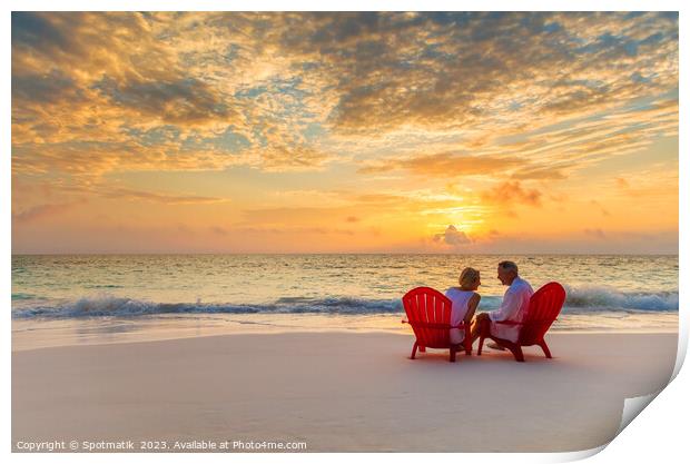 Mature couple enjoying ocean sunset on beach Bahamas Print by Spotmatik 