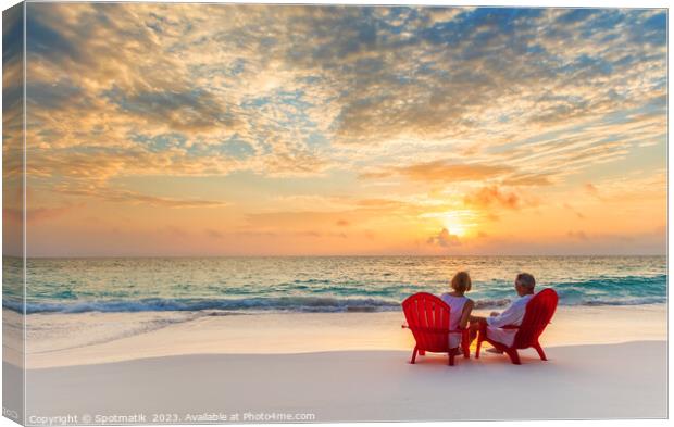 Retired couple enjoying tropical sunrise over ocean Bahamas Canvas Print by Spotmatik 