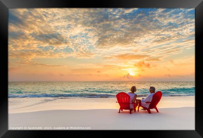 Retired couple enjoying tropical sunrise over ocean Bahamas Framed Print by Spotmatik 