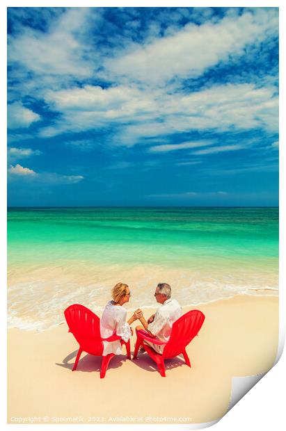 Mature couple on red chairs by ocean Bahamas Print by Spotmatik 