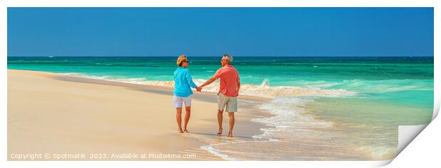 Panoramic beach view with retired couple holding hands Print by Spotmatik 