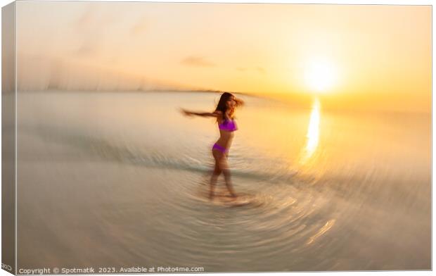 Motion blurred sunset ocean view with dancing female Canvas Print by Spotmatik 