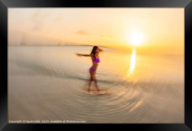 Motion blurred sunset ocean view with dancing female Framed Print by Spotmatik 