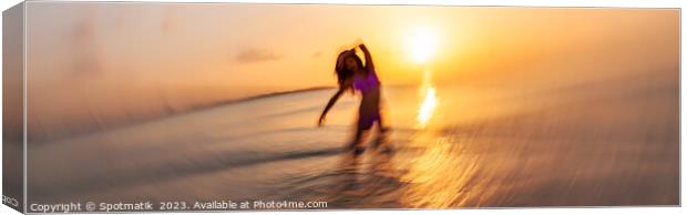 Panoramic ocean sunset with dancing female motion blur Canvas Print by Spotmatik 