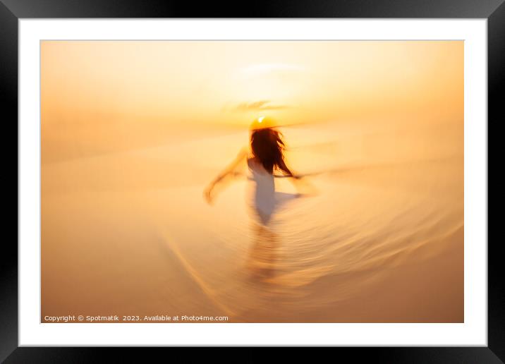 Motion blurred Asian girl dancing in ocean sunrise Framed Mounted Print by Spotmatik 