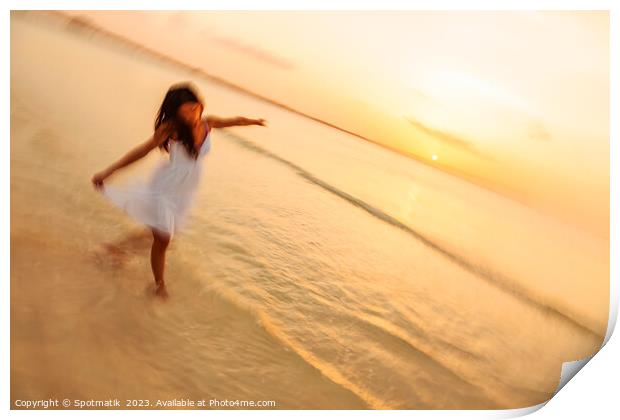 Motion blur carefree Asian female dancing on shoreline Print by Spotmatik 