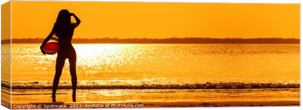 Panoramic Asian girl watching sunset over shimmering ocean Canvas Print by Spotmatik 