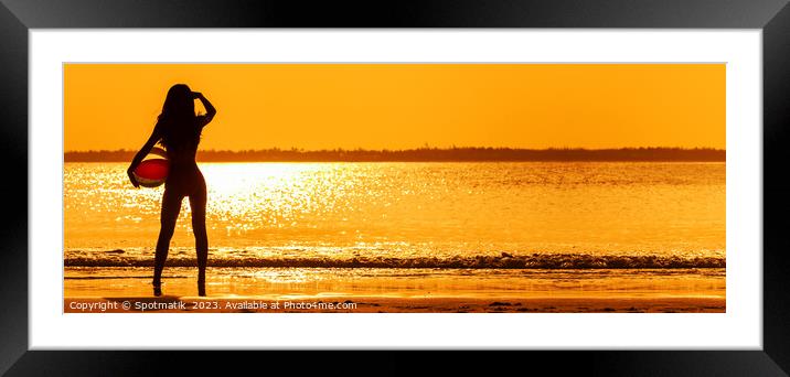 Panoramic Asian girl watching sunset over shimmering ocean Framed Mounted Print by Spotmatik 