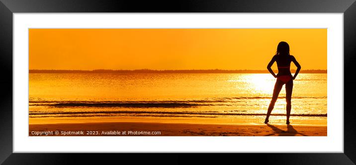 Panoramic silhouette of girl watching tropical ocean sunset Framed Mounted Print by Spotmatik 