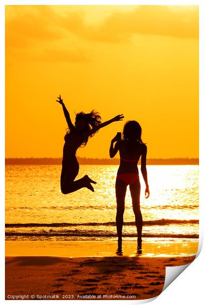 Tropical ocean sunrise with girl photographing friend jumping Print by Spotmatik 