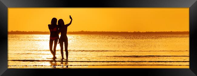 Panoramic ocean sunrise with females silhouette taking selfie Framed Print by Spotmatik 