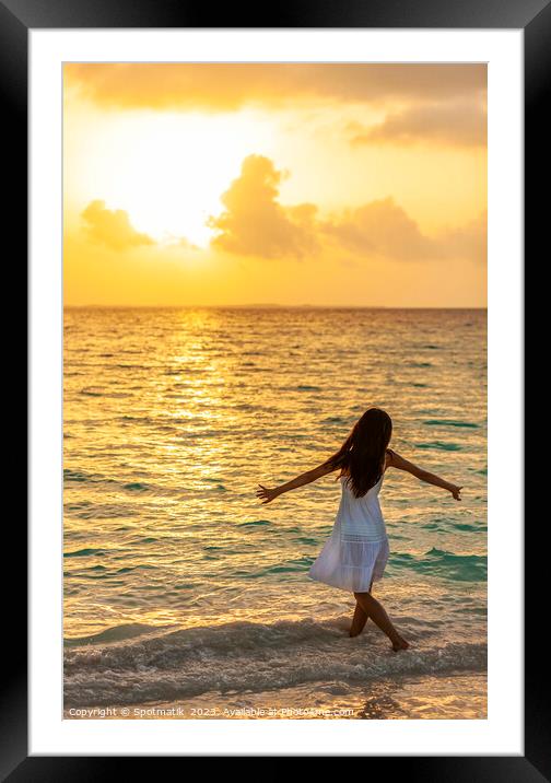 Asian female dancing in ocean waves at sunrise Framed Mounted Print by Spotmatik 