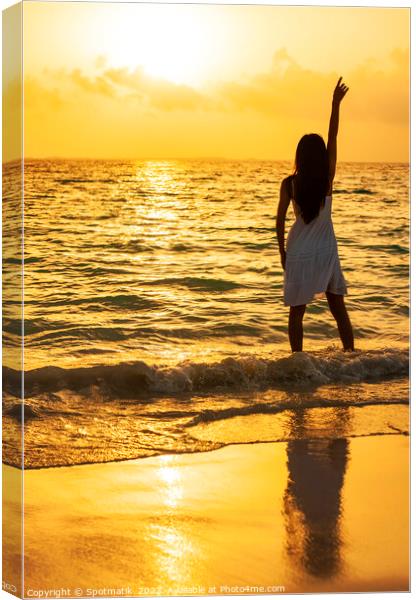 Young Asian woman enjoying ocean sunset on vacation Canvas Print by Spotmatik 