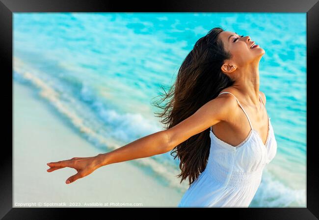 Young Asian female having fun on ocean shoreline Framed Print by Spotmatik 