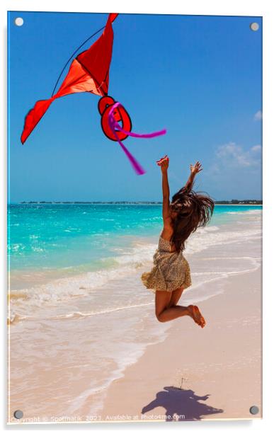 Happy Asian girl jumping by ocean flying kite Acrylic by Spotmatik 