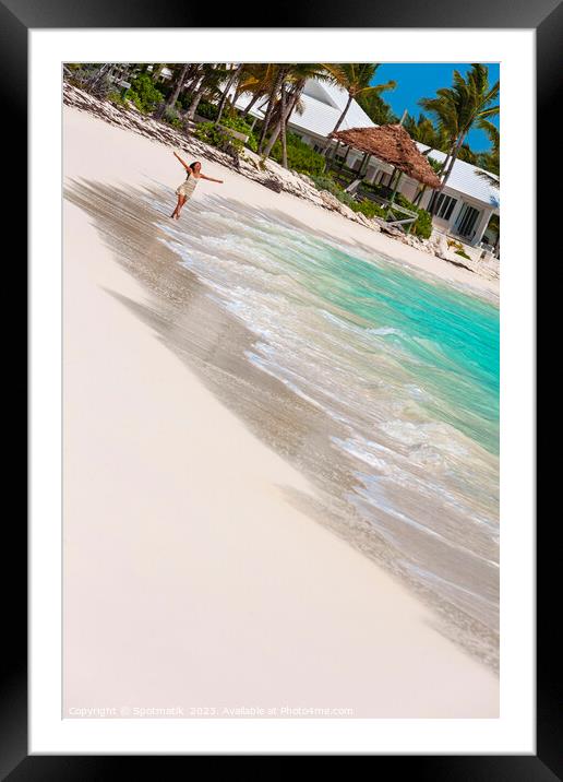 Asian female walking along shoreline with arms outstretched Framed Mounted Print by Spotmatik 