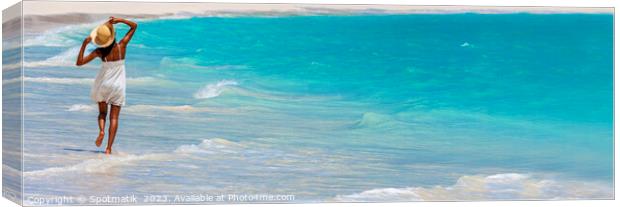 Panoramic young woman walking happily in ocean waves Canvas Print by Spotmatik 